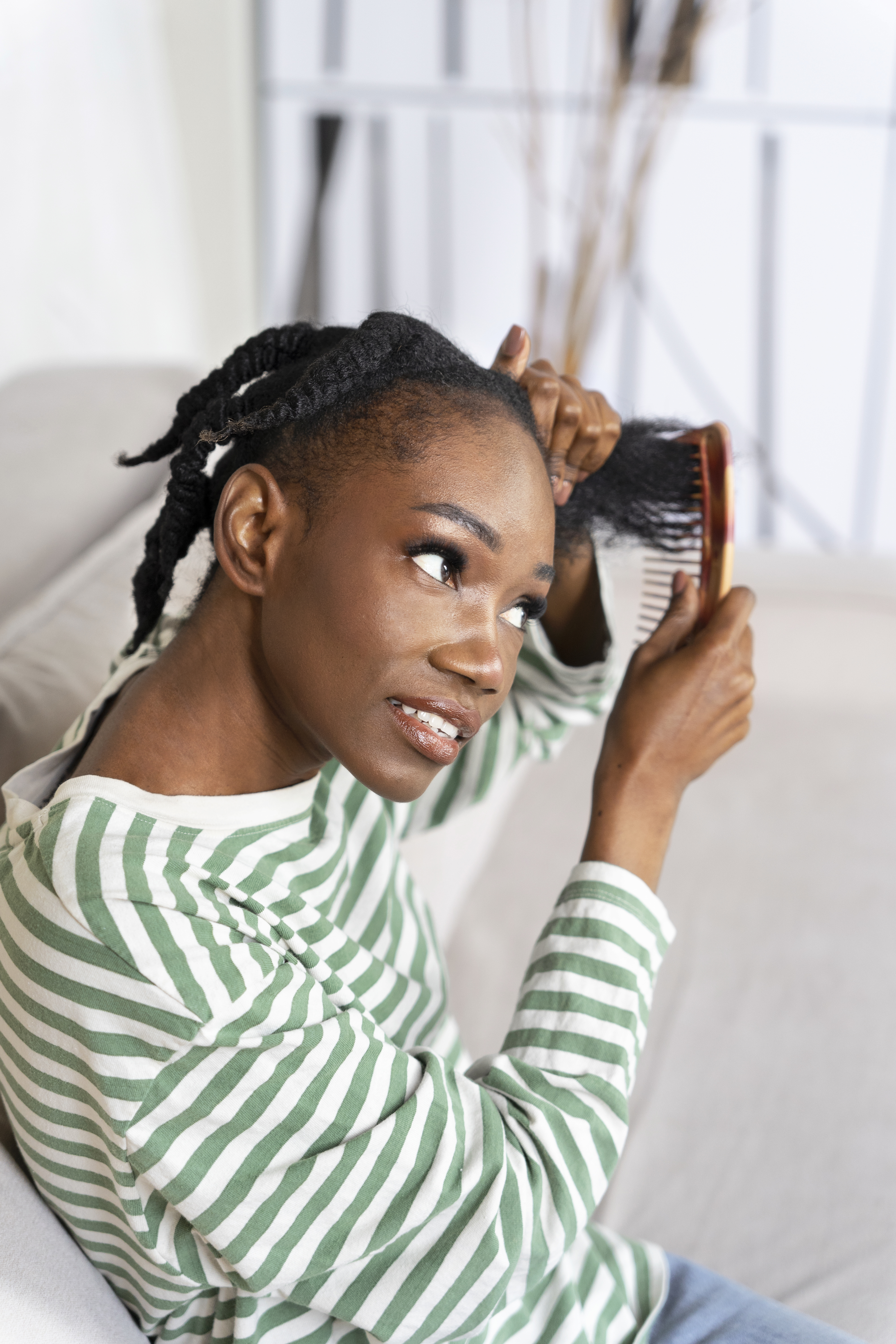 side view smiley woman combing hair