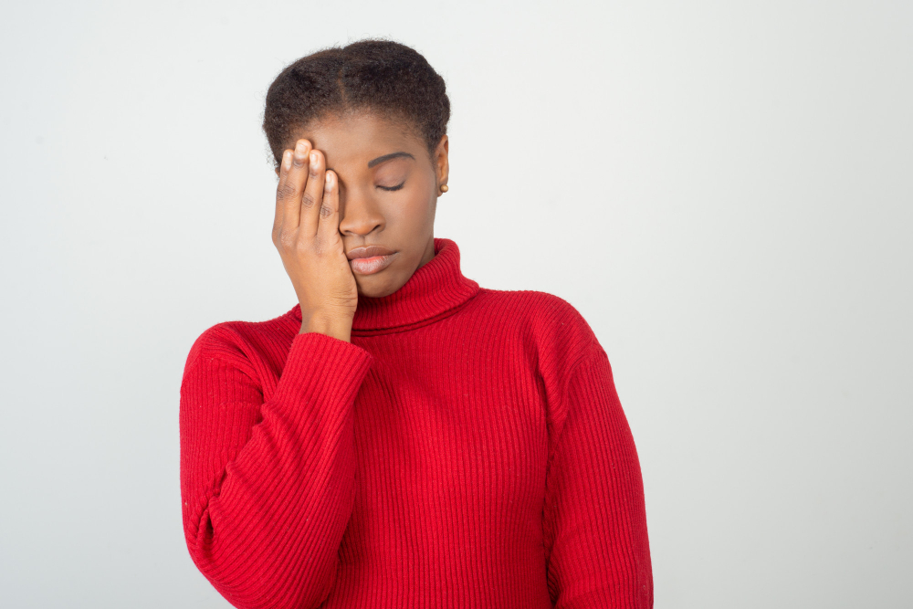 exhausted young woman holding hand head 1