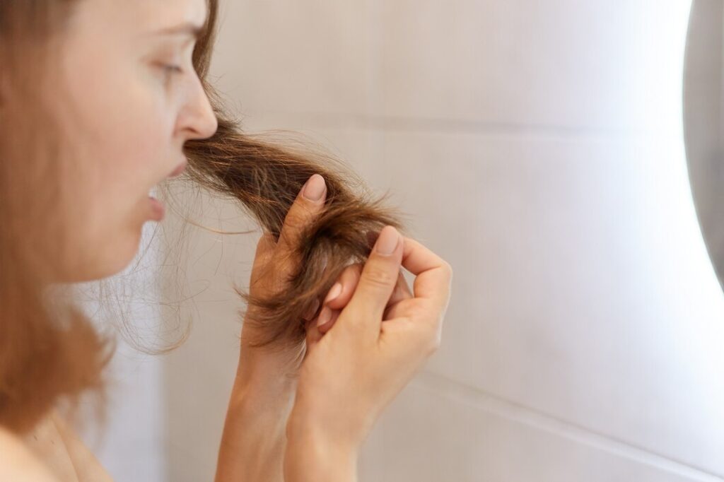 closeup profile portrait upset astonished woman looking her dry hair having problems needs change shampoo special treatment trichological clinic 176532 14933