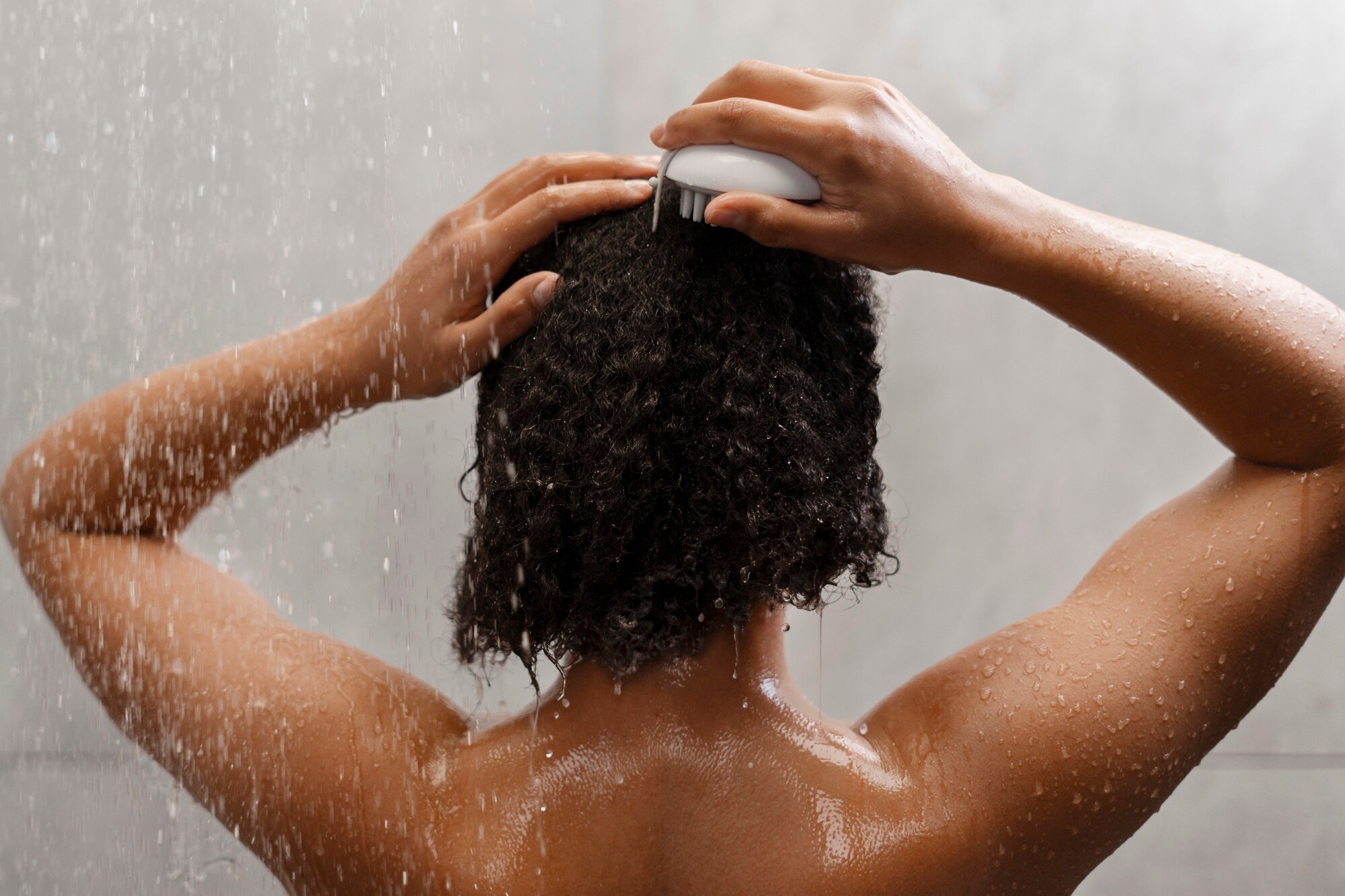 woman giving herself scalp massage