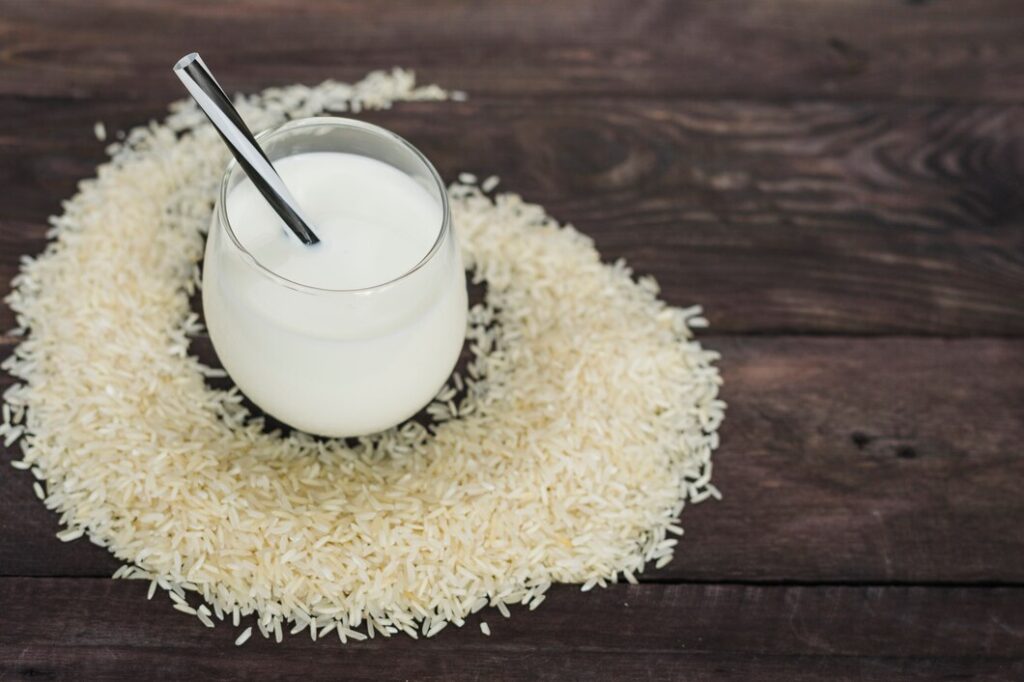 glass homemade rice milk decorated with white raw rice wooden table 23 2148097271