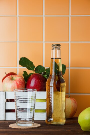 side view apples box with apple juice wooden orange tile background vertical space text 176474 7920